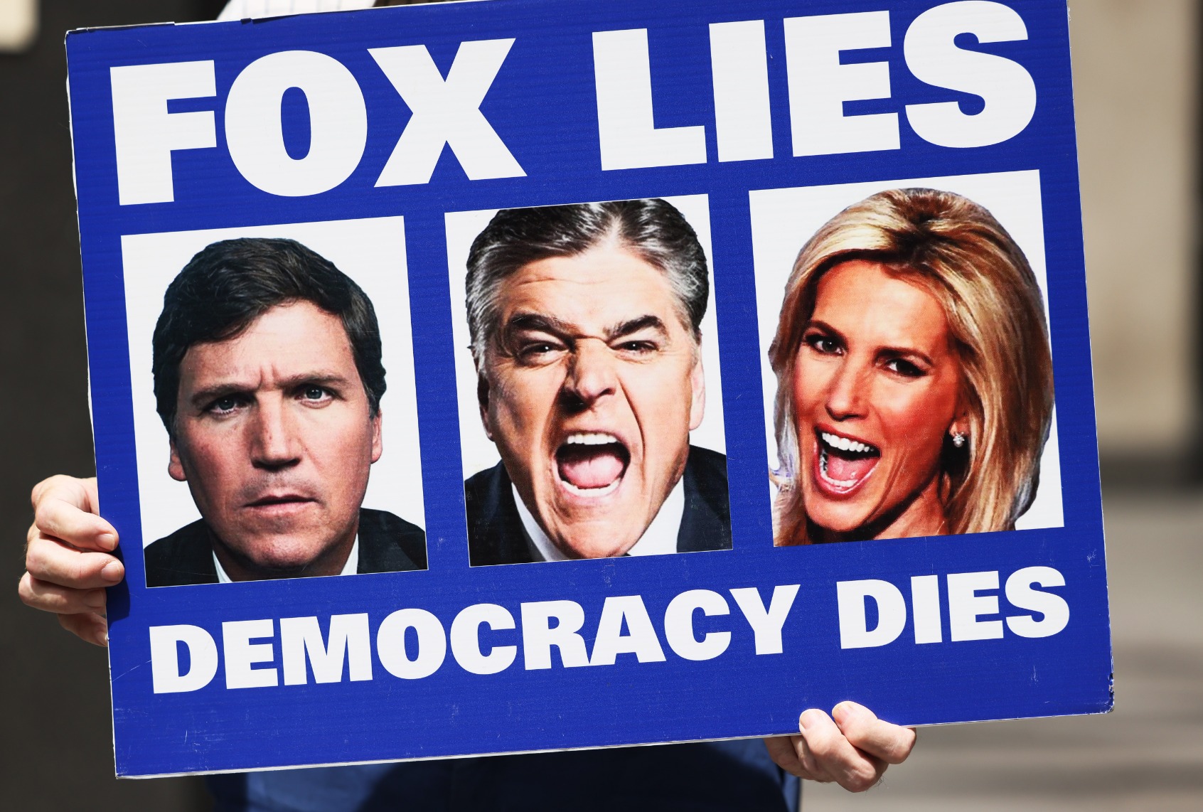 A person holds up as sign in a "Fox can't handle the truth" protest outside Fox News headquarters on June 14, 2022 in New York City. (Michael M. Santiago/Getty Images)