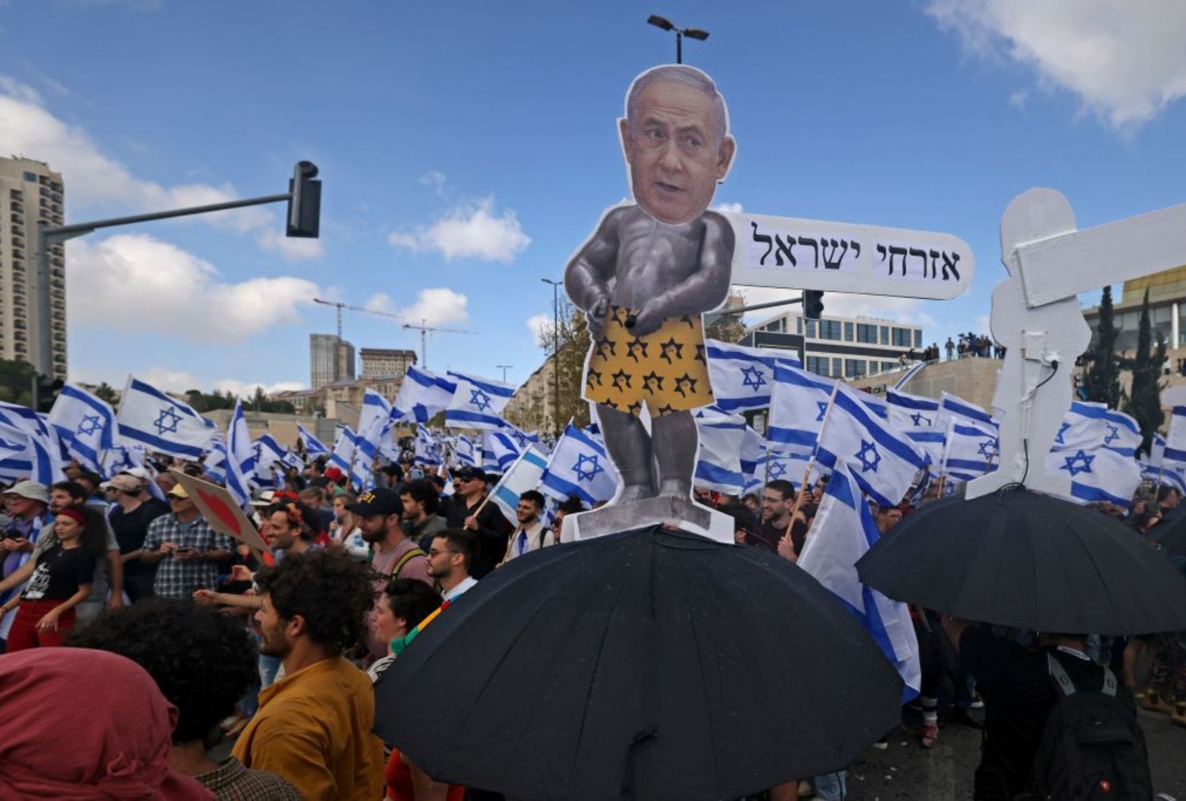 Protesters gather outside Israel's parliament in Jerusalem amid ongoing demonstrations and calls for a general strike against the hard-right government's controversial push to overhaul the justice system, on March 27, 2023. (AHMAD GHARABLI/AFP via Getty Images)