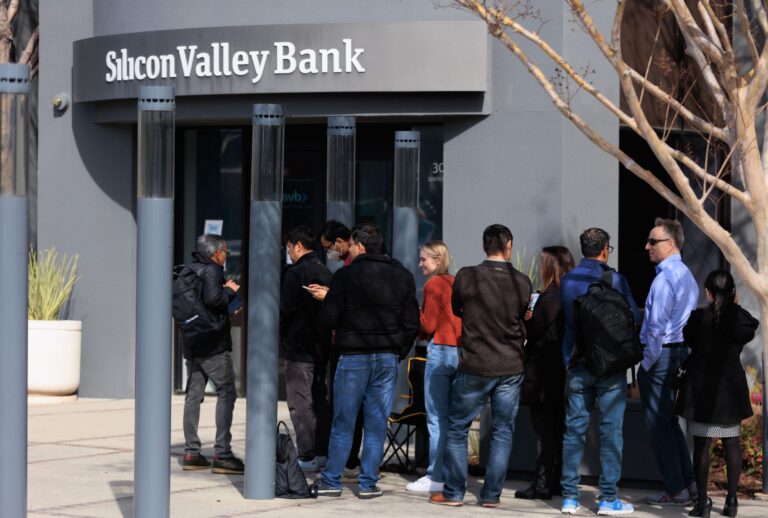 People wait outside the Silicon Valley Bank headquarters in Santa Clara, CA, to withdraw funds after the federal government intervened upon the bank's collapse, on March 13, 2023. (Nikolas Liepins/Anadolu Agency via Getty Images)