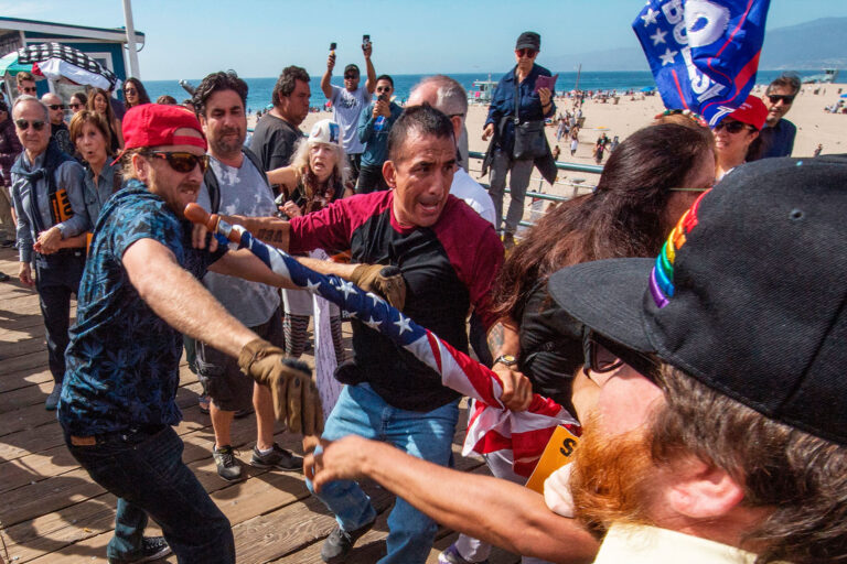 Supporters of President Donald Trump (L) clash with anti-Trump protesters during a rally against his policies in Santa Monica, California on October 19, 2019. (MARK RALSTON/AFP via Getty Images)