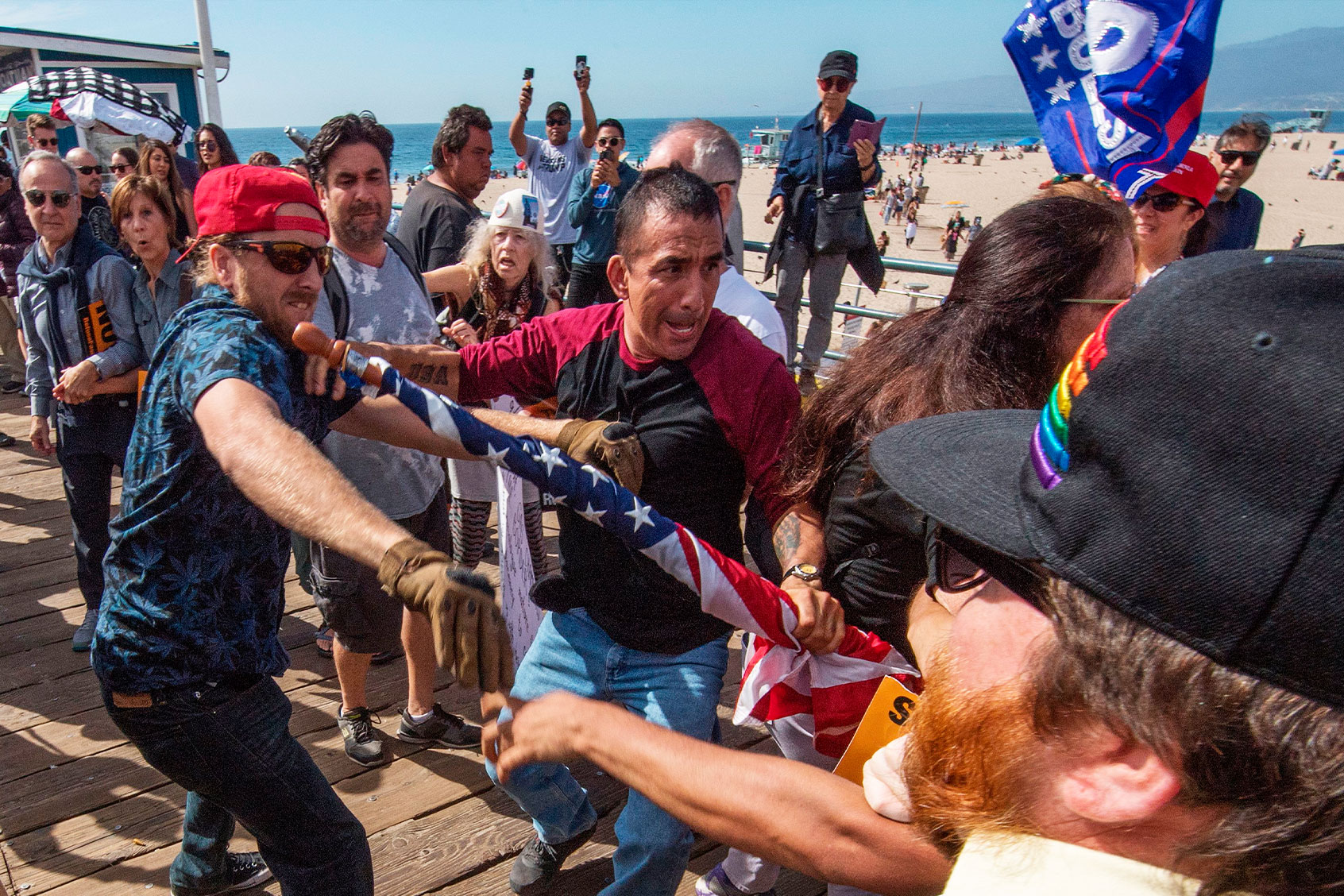 Supporters of President Donald Trump (L) clash with anti-Trump protesters during a rally against his policies in Santa Monica, California on October 19, 2019. (MARK RALSTON/AFP via Getty Images)