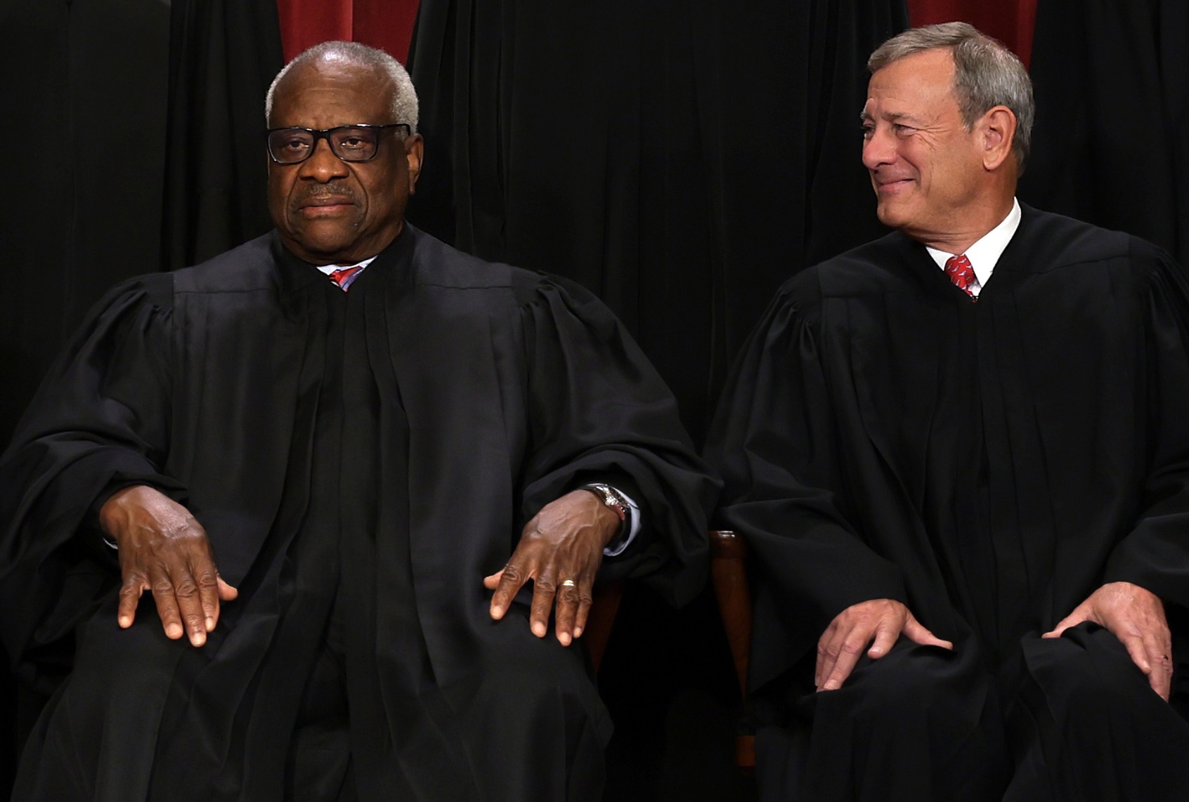 United States Supreme Court Associate Justice Clarence Thomas (L) and Chief Justice of the United States John Roberts (R) on October 7, 2022 in Washington, DC. (Alex Wong/Getty Images)