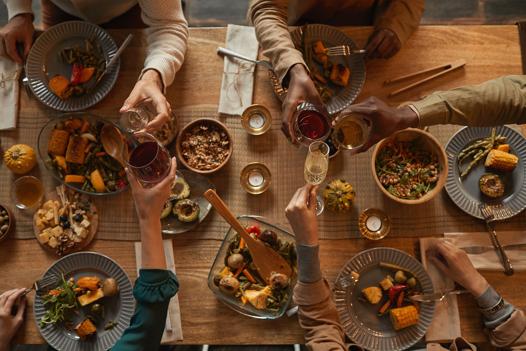 Group of people enjoying a dinner party with friends and family (Getty Images/SeventyFour)