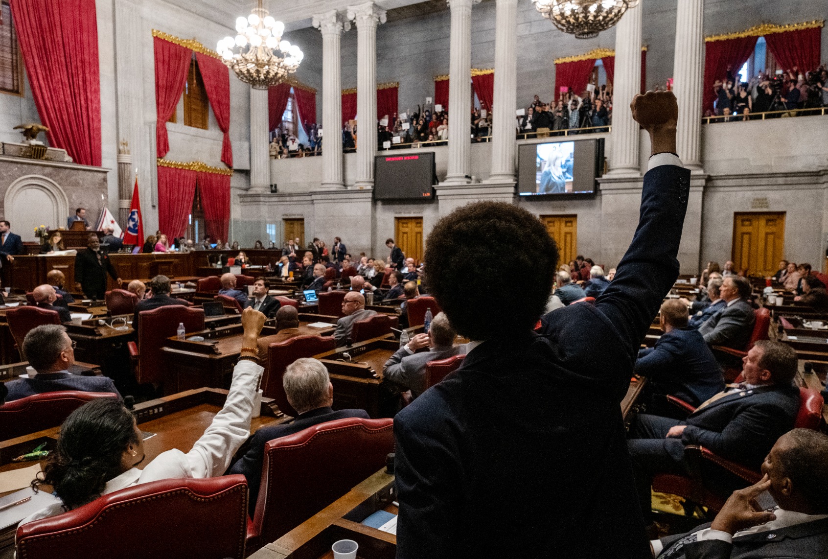 Democratic state Reps. Justin Jones (Lower, L) of Nashville and Justin Pearson (C) of Memphis gesture to supporters during the vote in which they were expelled from the state Legislature on April 6, 2023 in Nashville, Tennessee. (Seth Herald/Getty Images))
