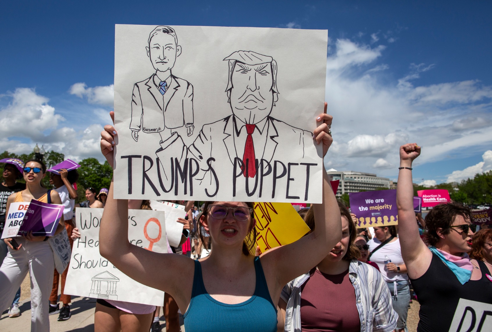 An abortion rights activist holds a sign with a sketch of Judge Matthew Joseph Kacsmaryk and former president Donald Trump while joining in a rally in support of abortion rights. (Probal Rashid/LightRocket via Getty Images)