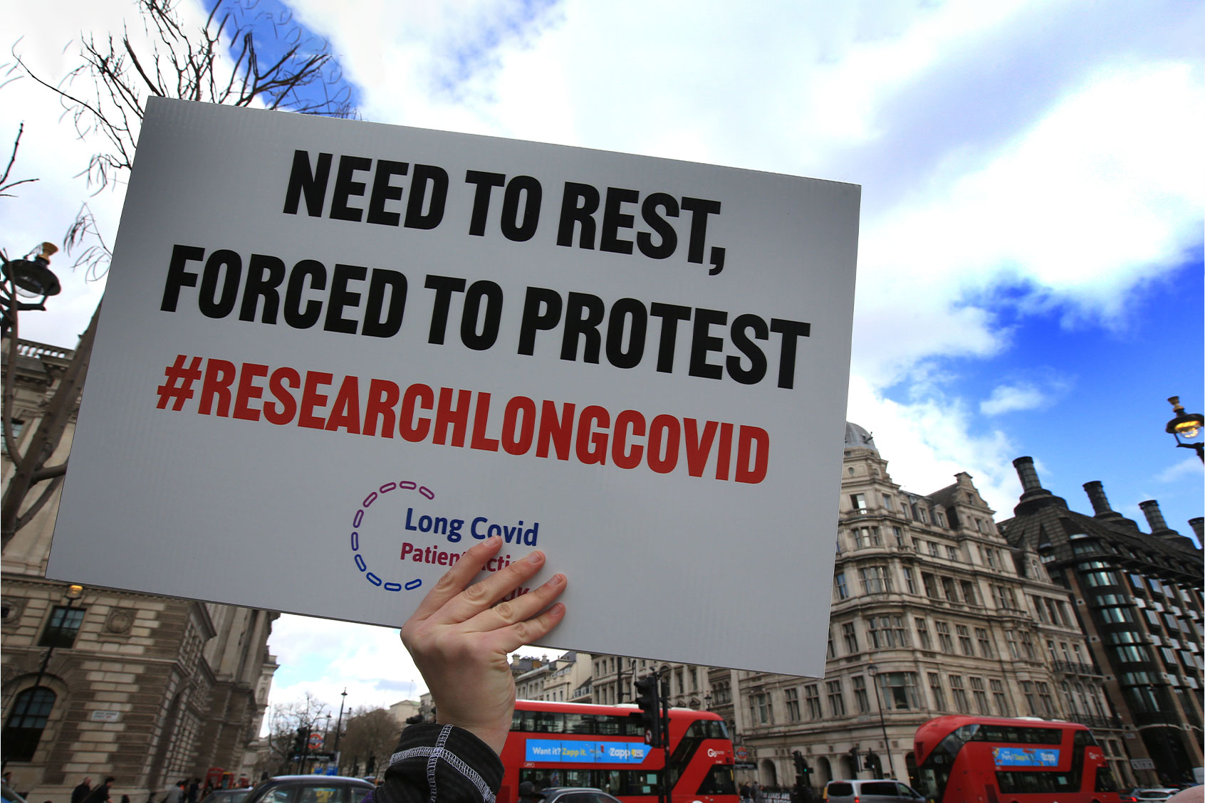 A protester holds up a placard demanding research into Long Covid-19 during the demonstration. (Martin Pope/SOPA Images/LightRocket via Getty Images)