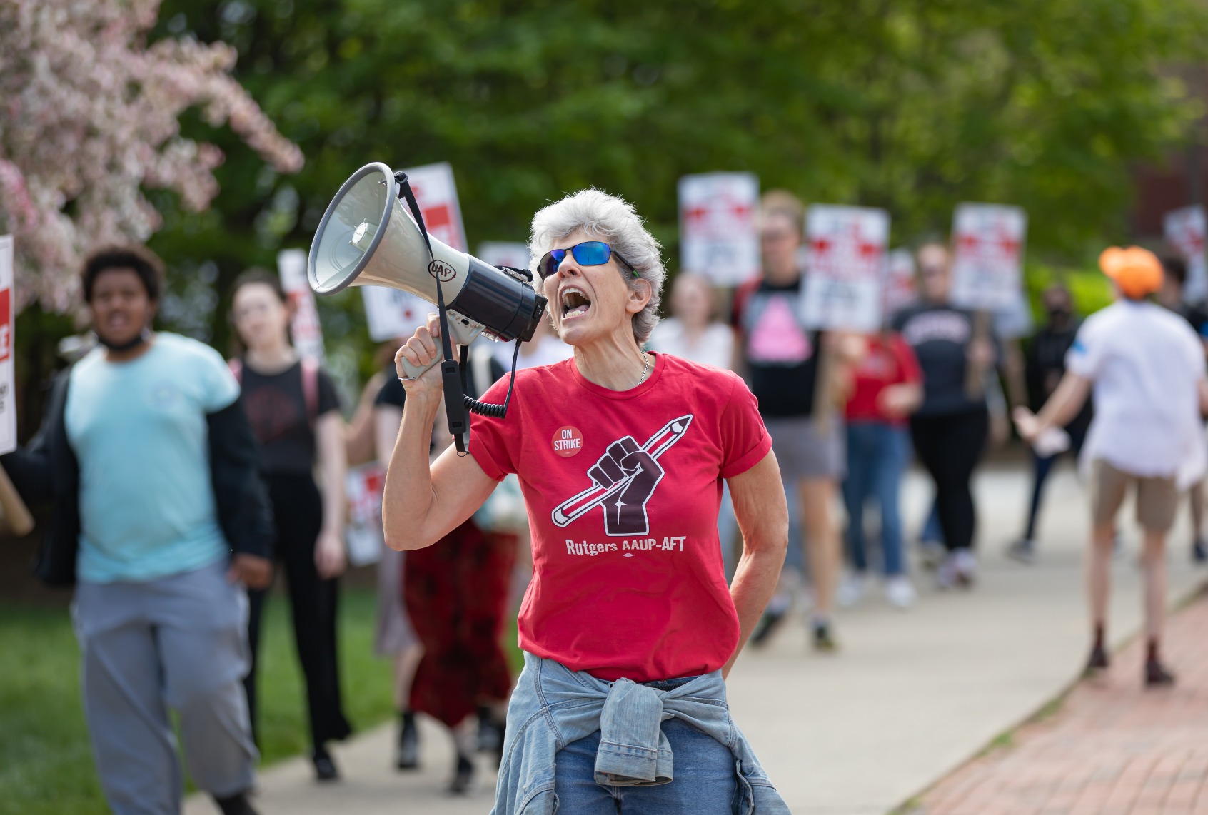A protester with a bullhorn leads chants with Rutgers students and faculty as they participate in a strike at the university's main campus in New Brunswick. (Michael Nigro/Pacific Press/LightRocket via Getty Images)