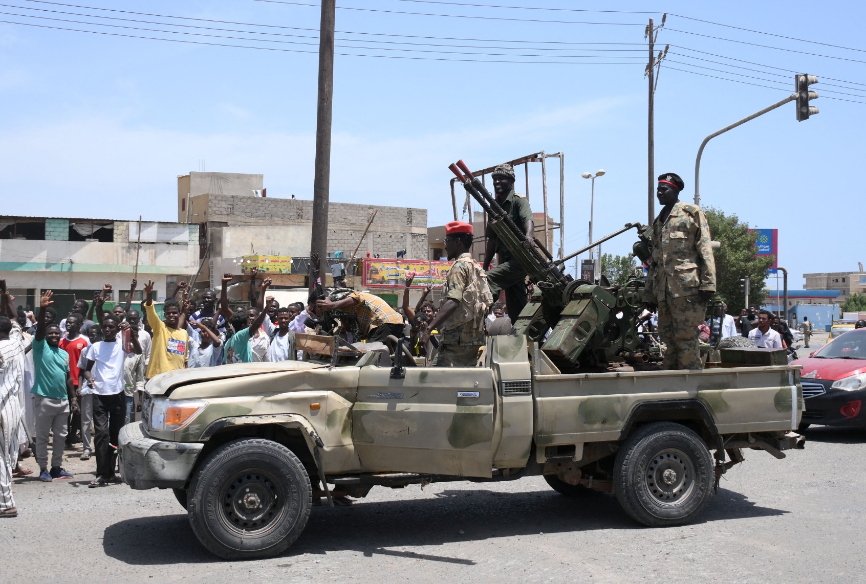 Sudanese greet army soldiers, loyal to army chief Abdel Fattah al-Burhan, in the Red Sea city of Port Sudan on April 16, 2023. (AFP via Getty Images)