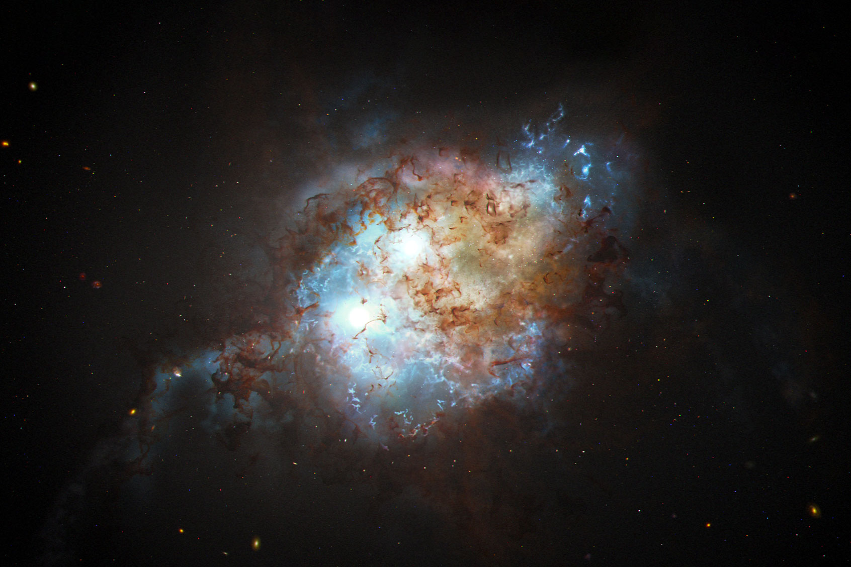 This artist's concept shows the brilliant glare of two quasars residing in the cores of two galaxies that are in the chaotic process of merging. (NASA, ESA, Joseph Olmsted (STScI))