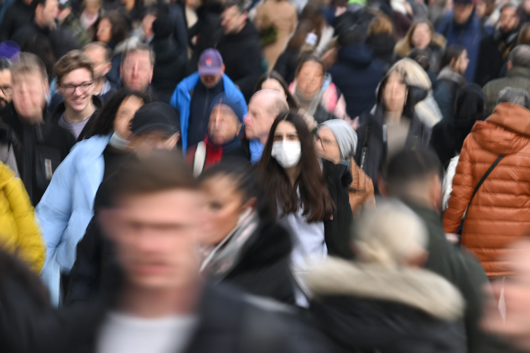 A woman wearing a mask walks in the crowd (Arne Dedert/picture alliance via Getty Images)