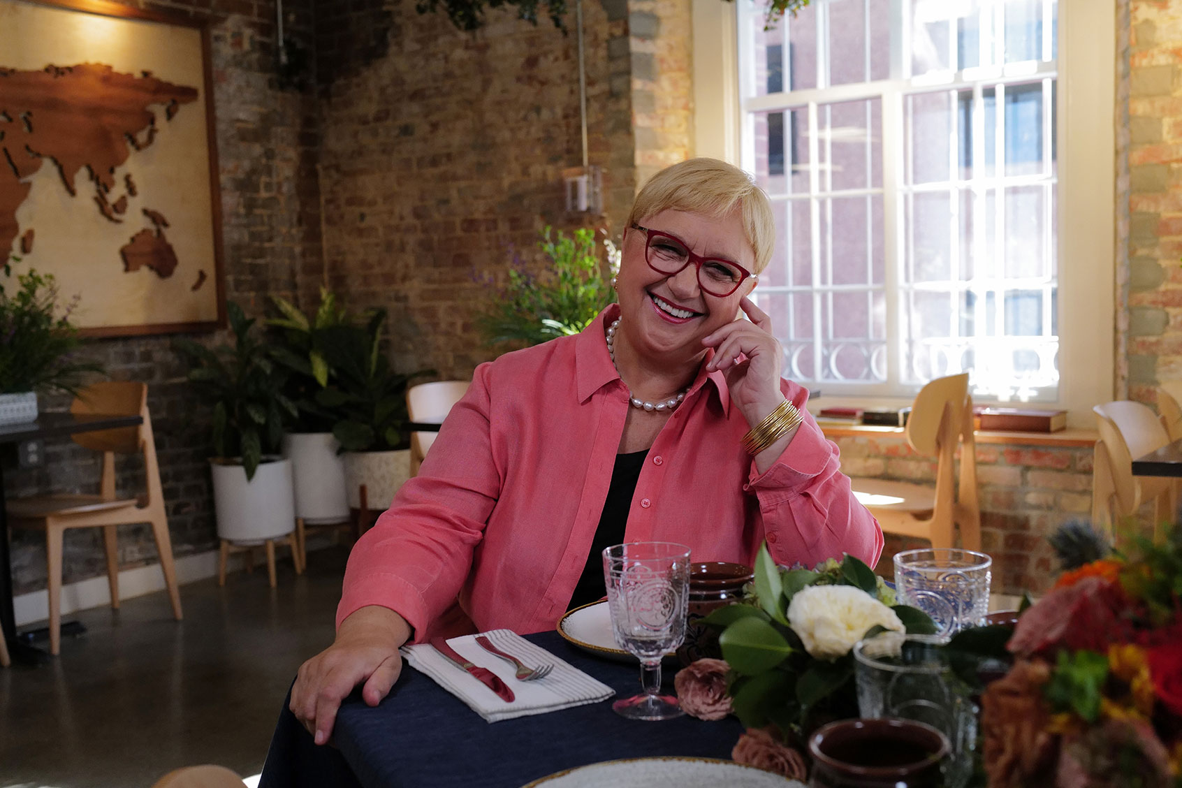 With the table set, Lidia is ready to welcome guests to Immigrant Food in “Lidia Celebrates America: Flavors That Define Us” (Meredith Nierman/GBH & Tavola Productions)