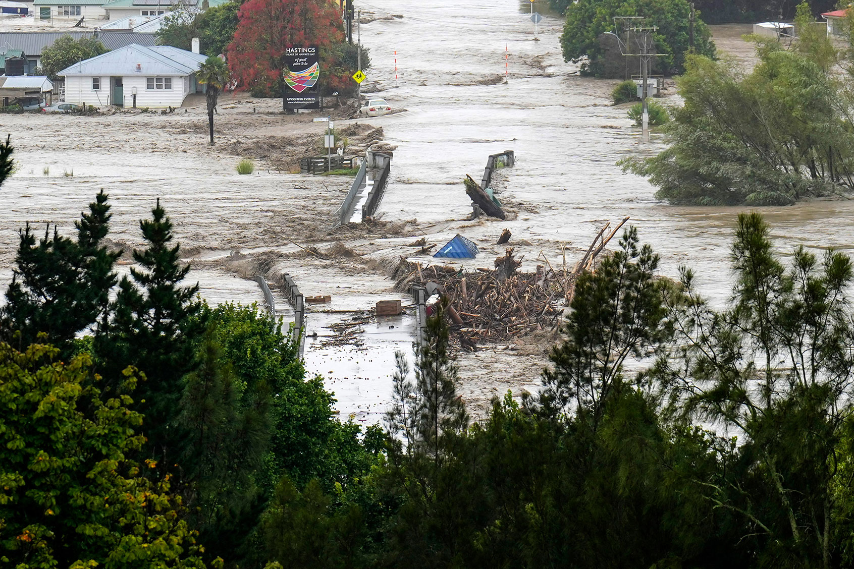 An aerial photo taken on February 14, 2023 shows the Waiohiki bridge and surrounds inundated by the Tutaekuri River after Cyclone Gabrielle made landfall near the city of Napier. (STR/AFP via Getty Images)