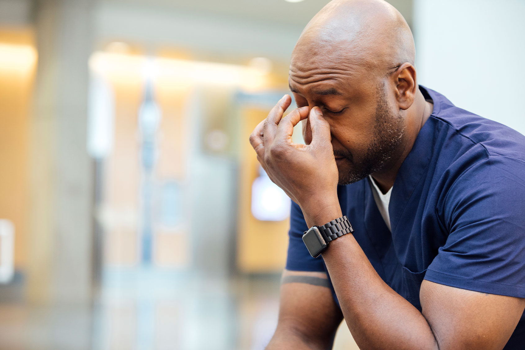 Tired man pinching brow (Getty Images/The Good Brigade)
