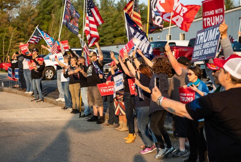 Supporters of former President Donald Trump cheer as his motorcade drives by outside Manchester airport in Manchester, New Hampshire, on May 10, 2023 ahead of his CNN town hall. (JOSEPH PREZIOSO/AFP via Getty Images)