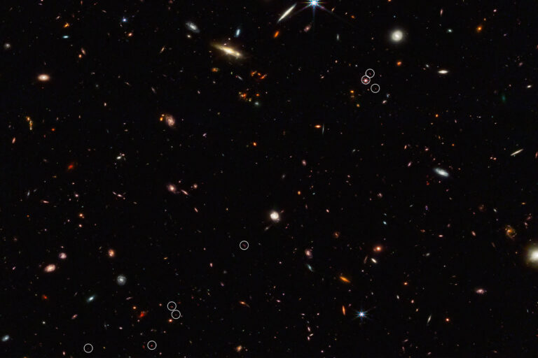 This deep galaxy field from Webb’s NIRCam (Near-Infrared Camera) shows an arrangement of 10 distant galaxies marked by eight white circles in a diagonal, thread-like line. (Two of the circles contain more than one galaxy.) This 3 million light-year-long filament is anchored by a very distant and luminous quasar – a galaxy with an active, supermassive black hole at its core. (NASA, ESA, CSA, Feige Wang (University of Arizona), Joseph DePasquale (STScI))