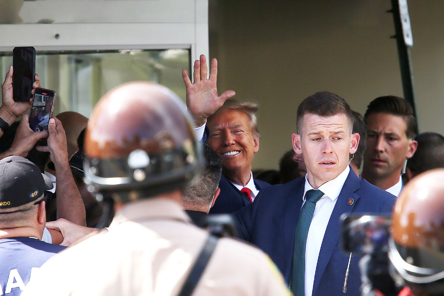 Former U.S. President Donald Trump waves as he makes a visit to the Cuban restaurant Versailles after he appeared for his arraignment on June 13, 2023 in Miami, Florida. (Alon Skuy/Getty Images)
