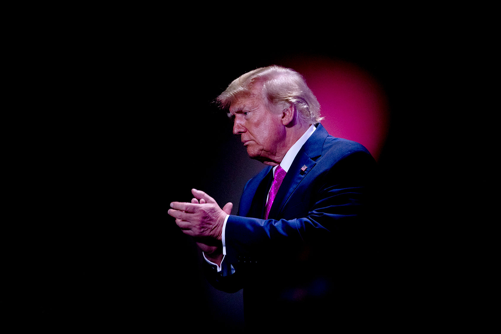 Former President Donald Trump claps after speaking during the Oakland County GOP Lincoln Day Dinner at the Suburban Collection Showplace in Novi, Michigan on June 25, 2023. (Emily Elconin for The Washington Post via Getty Images)