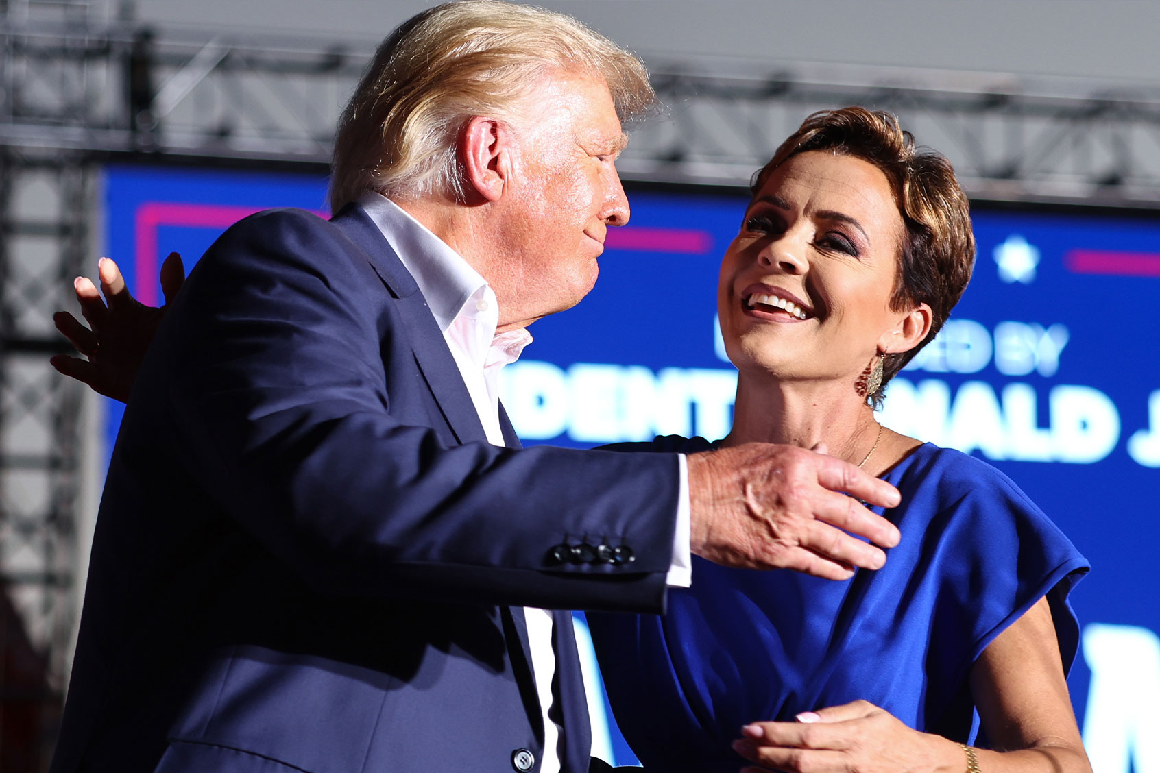 Former U.S. President Donald Trump embraces Arizona Republican gubernatorial nominee Kari Lake at a campaign rally at Legacy Sports USA on October 09, 2022 in Mesa, Arizona. (Mario Tama/Getty Images)