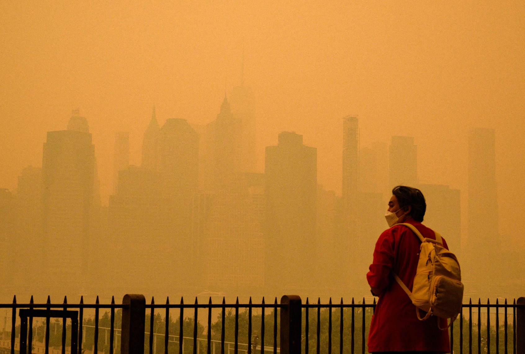 A person wears a face mask as smoke from wildfires in Canada cause hazy conditions in New York City on June 7, 2023. (ANGELA WEISS/AFP via Getty Images)