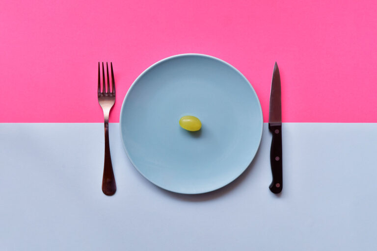 Dish with a single grape (Getty Images/miguelangelortega)