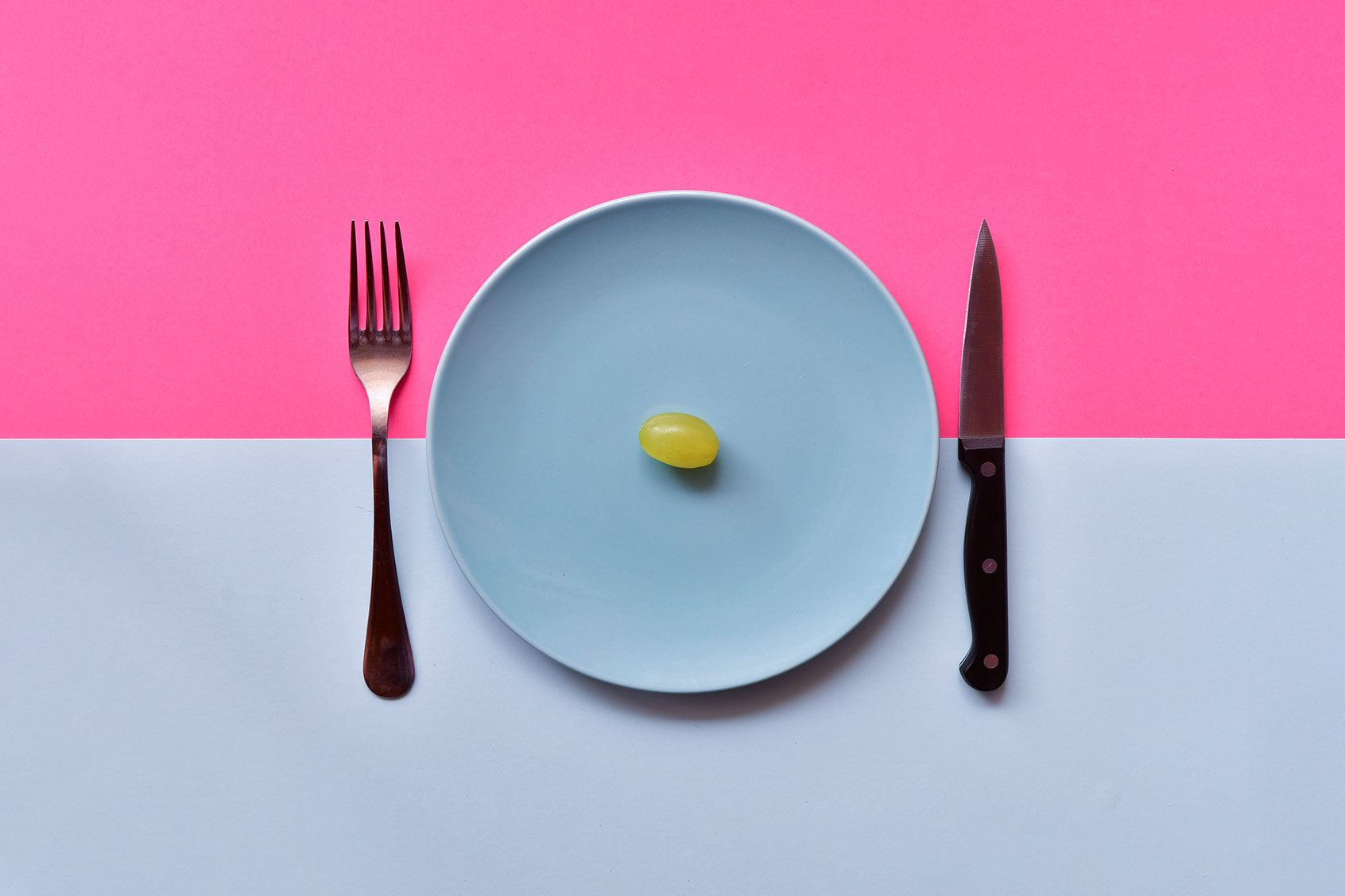 Dish with a single grape (Getty Images/miguelangelortega)