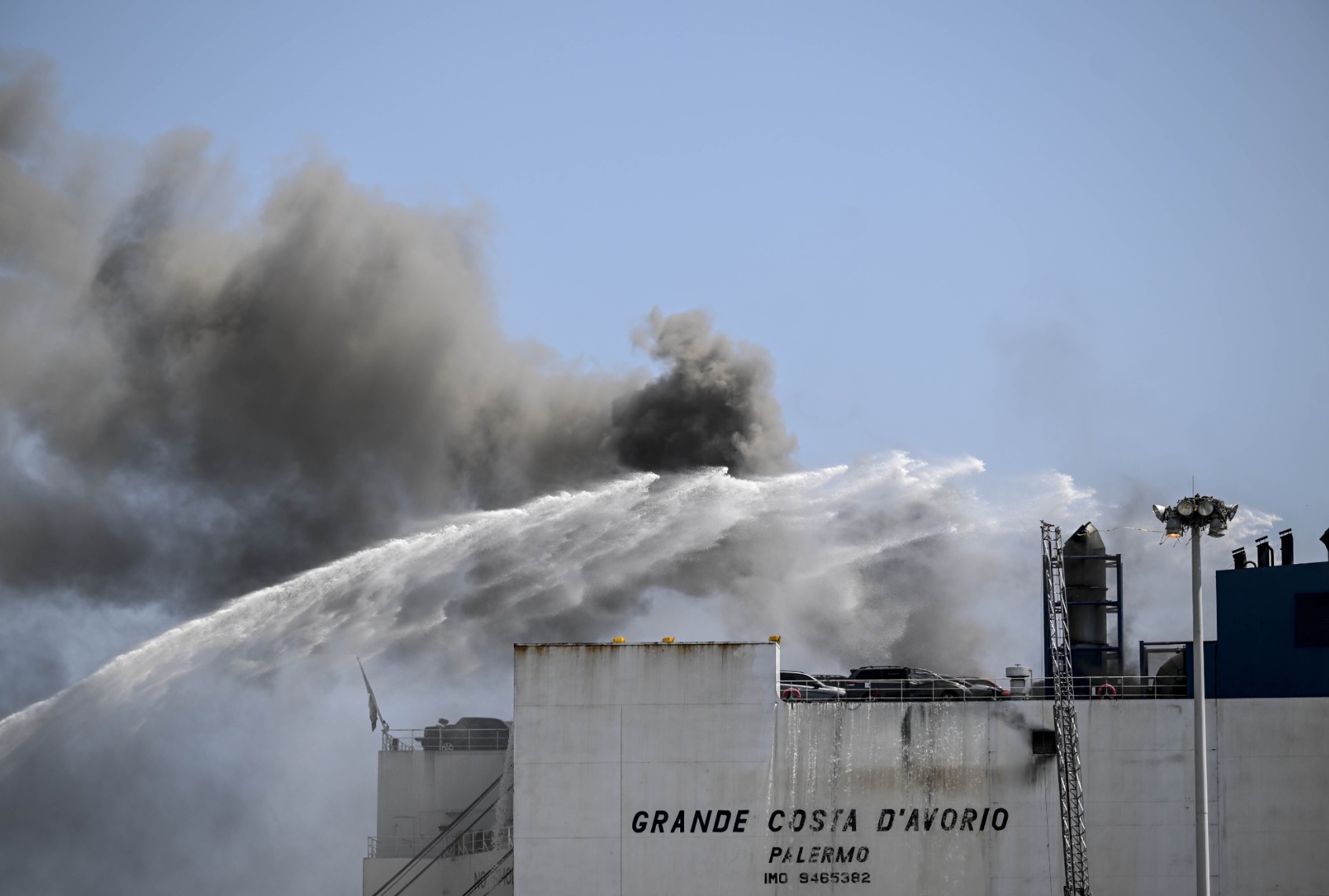 Firefighters respond a fire on a ship docked at Port Newark, New Jersey, United States on July 6, 2023. Two Newark firefighters died and five were injured late Wednesday as they battled a blaze on a massive cargo ship carrying vehicles in the port of Newark, New Jersey, officials said. (Fatih Aktas/Anadolu Agency via Getty Images)