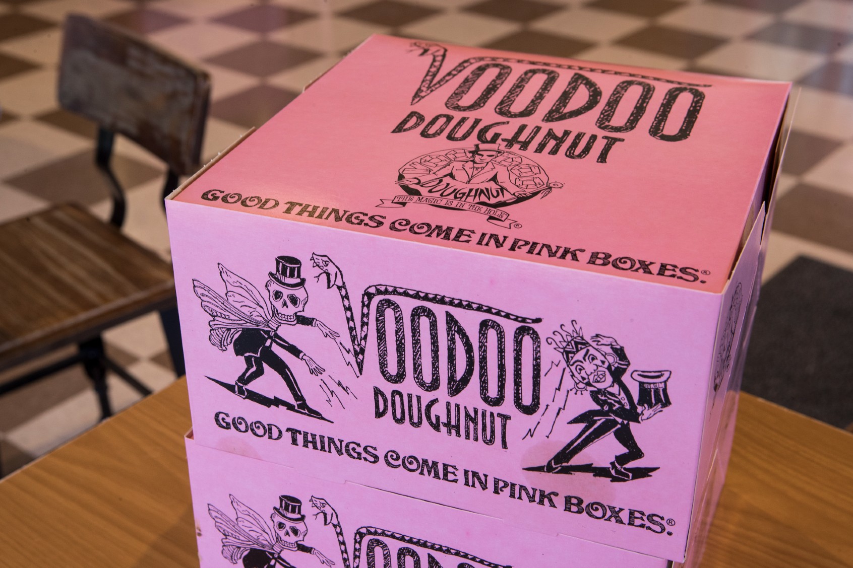 Pink doughnut boxes are shown in the dining room at Voodoo Doughnut on Tuesday, Jan. 7, 2020, in Houston. ( Brett Coomer/Houston Chronicle via Getty Images)