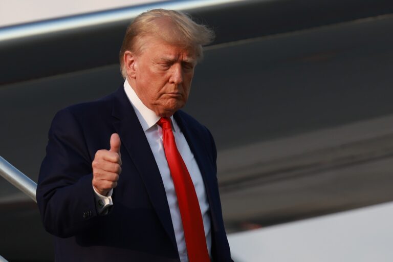 Former U.S. President Donald Trump gives a thumbs up as he arrives at Atlanta Hartsfield-Jackson International Airport on August 24, 2023 in Atlanta, Georgia. (Joe Raedle/Getty Images)