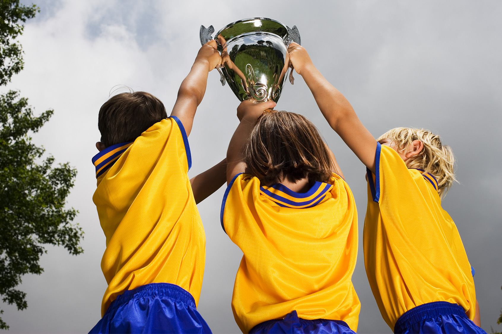Children in soccer uniforms holding a trophy (Getty Images / Heide Benser)