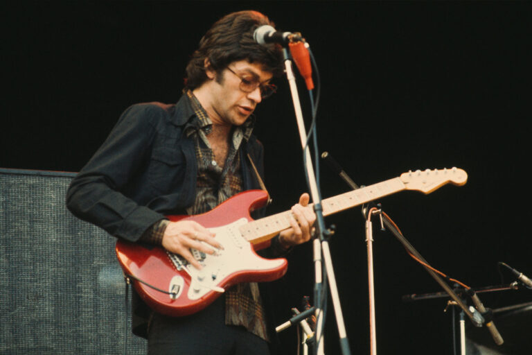 Canadian singer-songwriter and guitarist Robbie Robertson performing with The Band at Wembley, London, 14th September 1974. (Michael Putland/Getty Images)