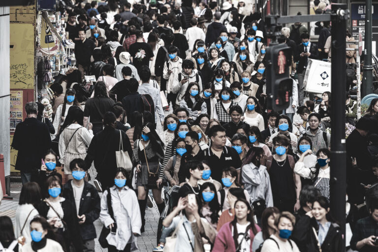 Crowds of people walk along the pavement at Shibuya Crossing, one of the busiest intersections in the world, in the Shibuya district of Tokyo on April 5, 2023. (RICHARD A. BROOKS/AFP via Getty Images)
