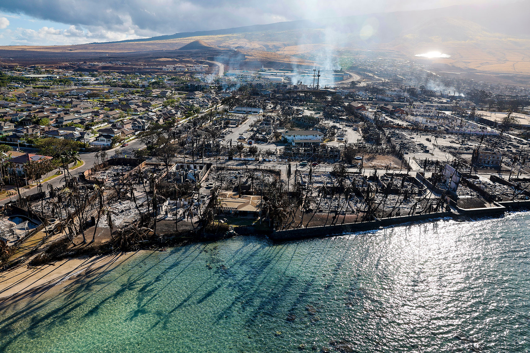 Buildings still smolder days after a wildfire gutted downtown Lahaina. (Robert Gauthier/Los Angeles Times via Getty Images)