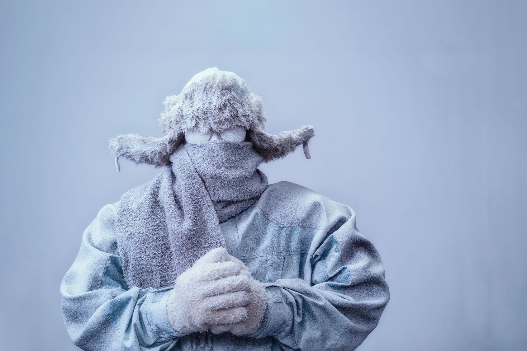 Man in parka, hat and scarf frozen from the cold (Getty Images/cmannphoto)