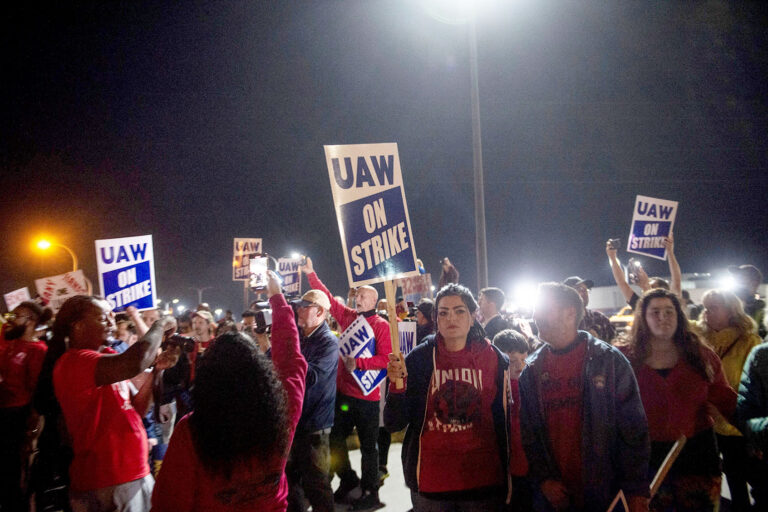 Members of the UAW (United Auto Workers) picket and hold signs outside of the UAW Local 900 headquarters across the street from the Ford Assembly Plant in Wayne, Michigan on September 15, 2023. (MATTHEW HATCHER/AFP via Getty Images)