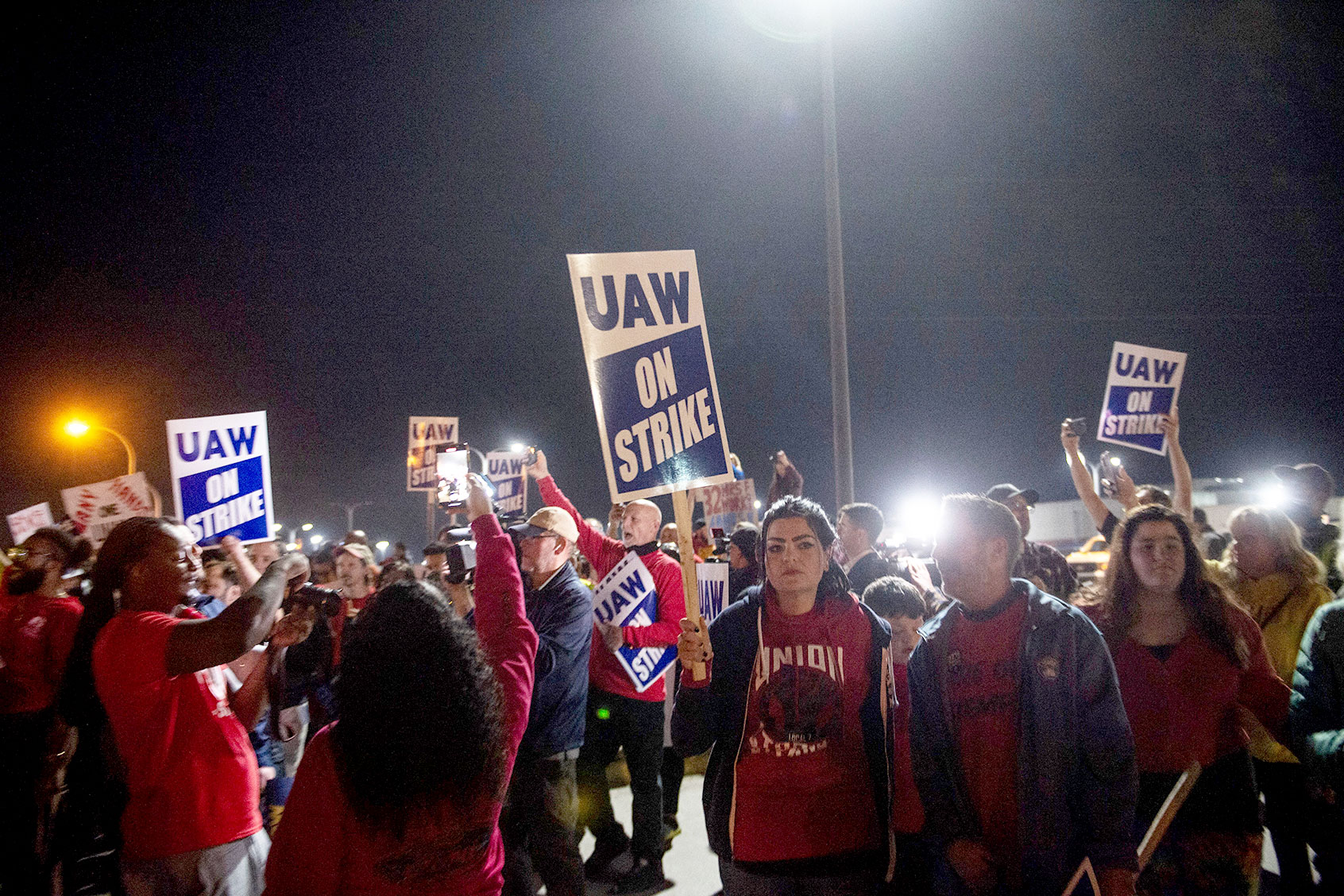 Members of the UAW (United Auto Workers) picket and hold signs outside of the UAW Local 900 headquarters across the street from the Ford Assembly Plant in Wayne, Michigan on September 15, 2023. (MATTHEW HATCHER/AFP via Getty Images)