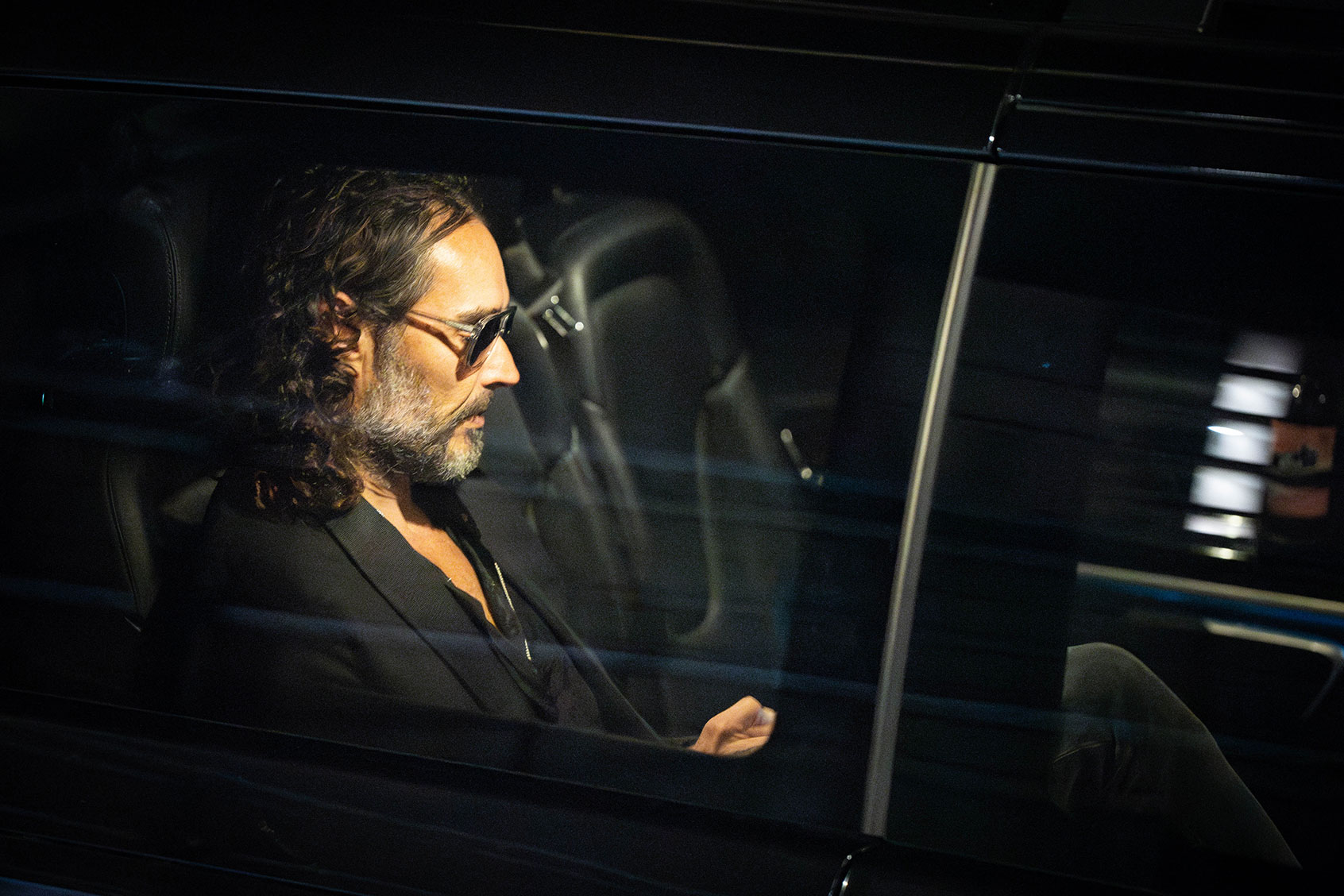 Russell Brand leaves the Troubabour Wembley Park theatre in north-west London after performing a comedy set, Saturday September 16, 2023. He faces claims about his sexual behaviour at the height of his fame. (James Manning/PA Images via Getty Images)
