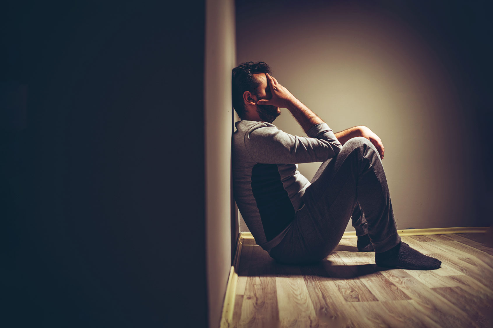 Young upset man sitting on floor (Getty Images/urbazon)