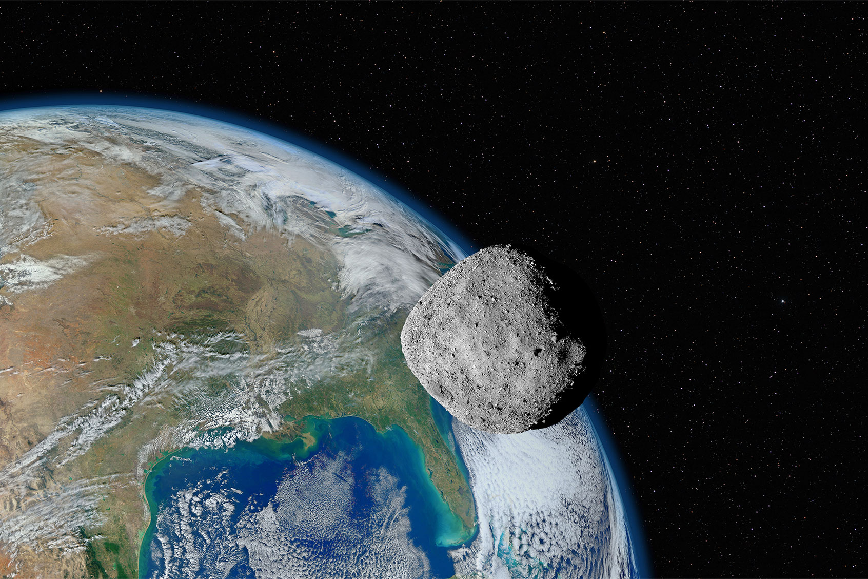 Asteroid approaching planet Earth (Getty Images/dzika_mrowka)