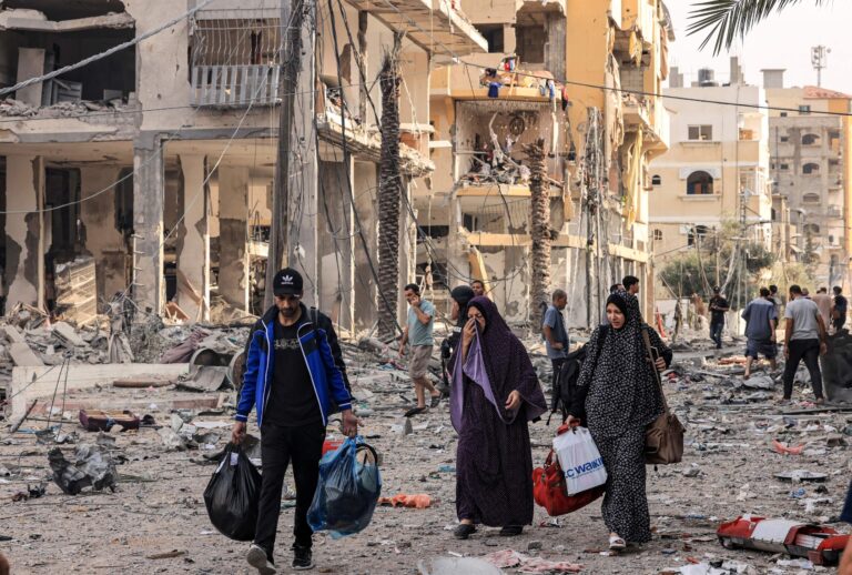 Palestinians leave al-Karama neighborhood in Gaza City to safer areas on October 11, 2023, as raging battles between Israel and the Hamas movement continued for the fifth consecutive day. (MAHMUD HAMS/AFP via Getty Images)