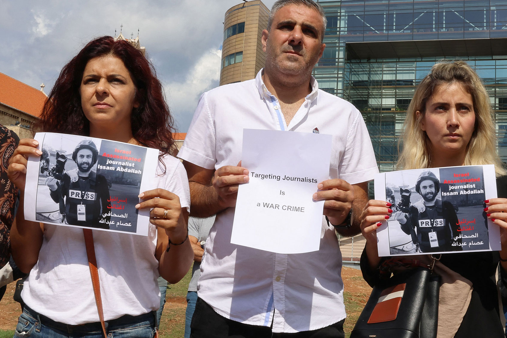 People lift placards and portraits of video journalist Issam Abdallah killed on October 13 by Israeli shelling at Alma al-Shaab border village with Israel while covering cross border shelling, during a protest facing UN headquarters in downtown Beirut on October 15, 2023. (JOSEPH EID/AFP via Getty Images)