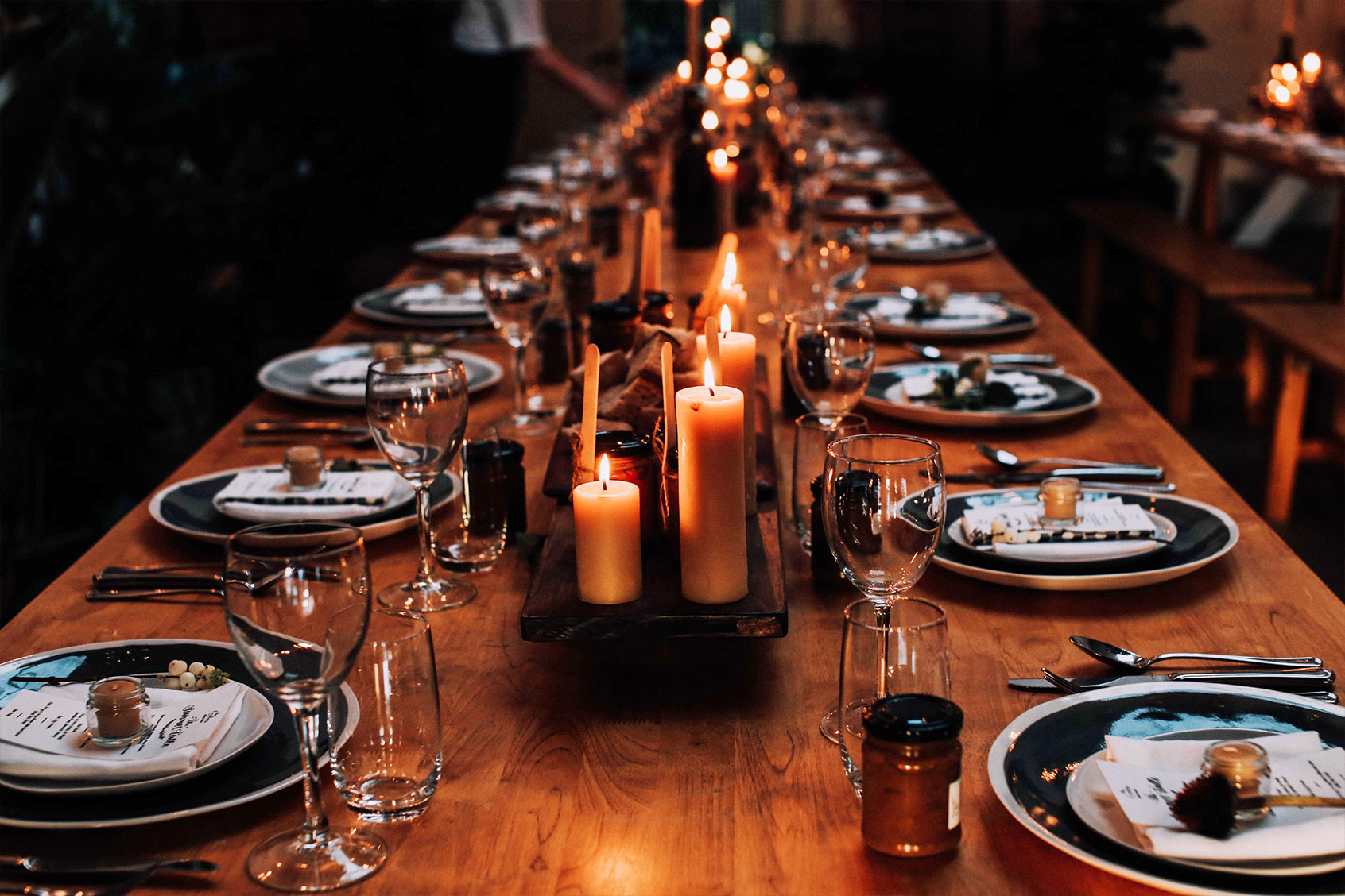 Lit candles on a set dining table (Getty Images/i_capturemoments/500px)