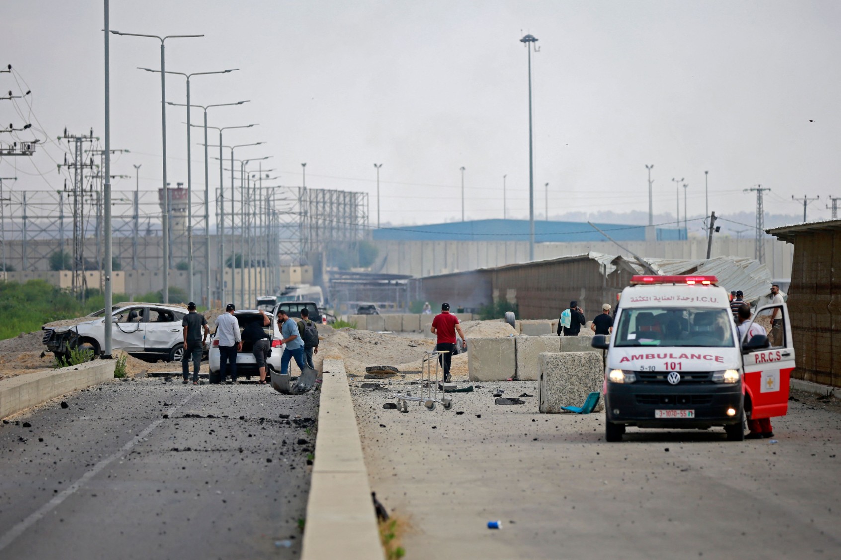 An ambulance is parked at the scene of an Israeli air strike at the Erez crossing between Israel and the northern Gaza Strip on October 7, 2023. (BASHAR TALEB/AFP via Getty Images)