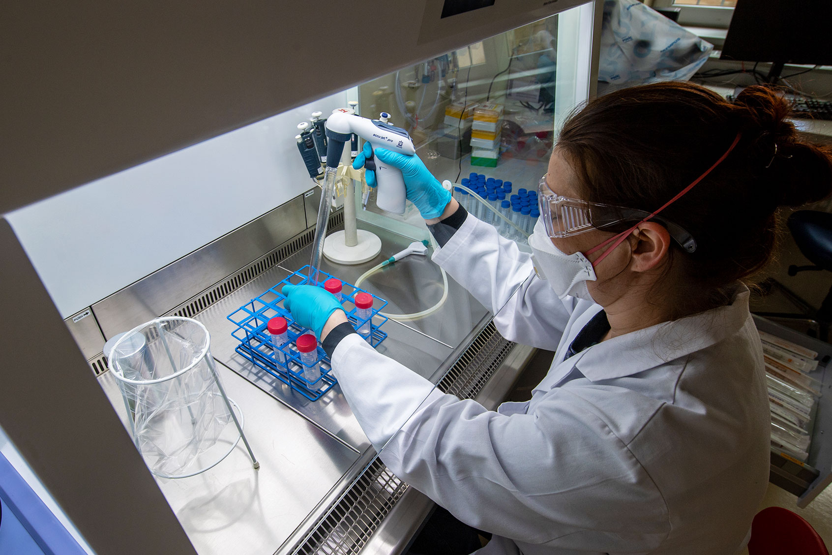 Swetlana Rot prepares water samples in a laboratory of the Saxony-Anhalt State Office for Environmental Protection in Halle/Saale. The scientists here examine wastewater for the coronavirus pathogen. (Hendrik Schmidt/picture alliance via Getty Images)