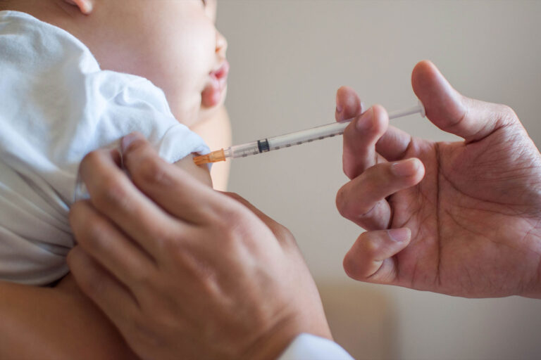 A doctor is injecting a vaccine to a baby (Getty Images/Karl Tapales)