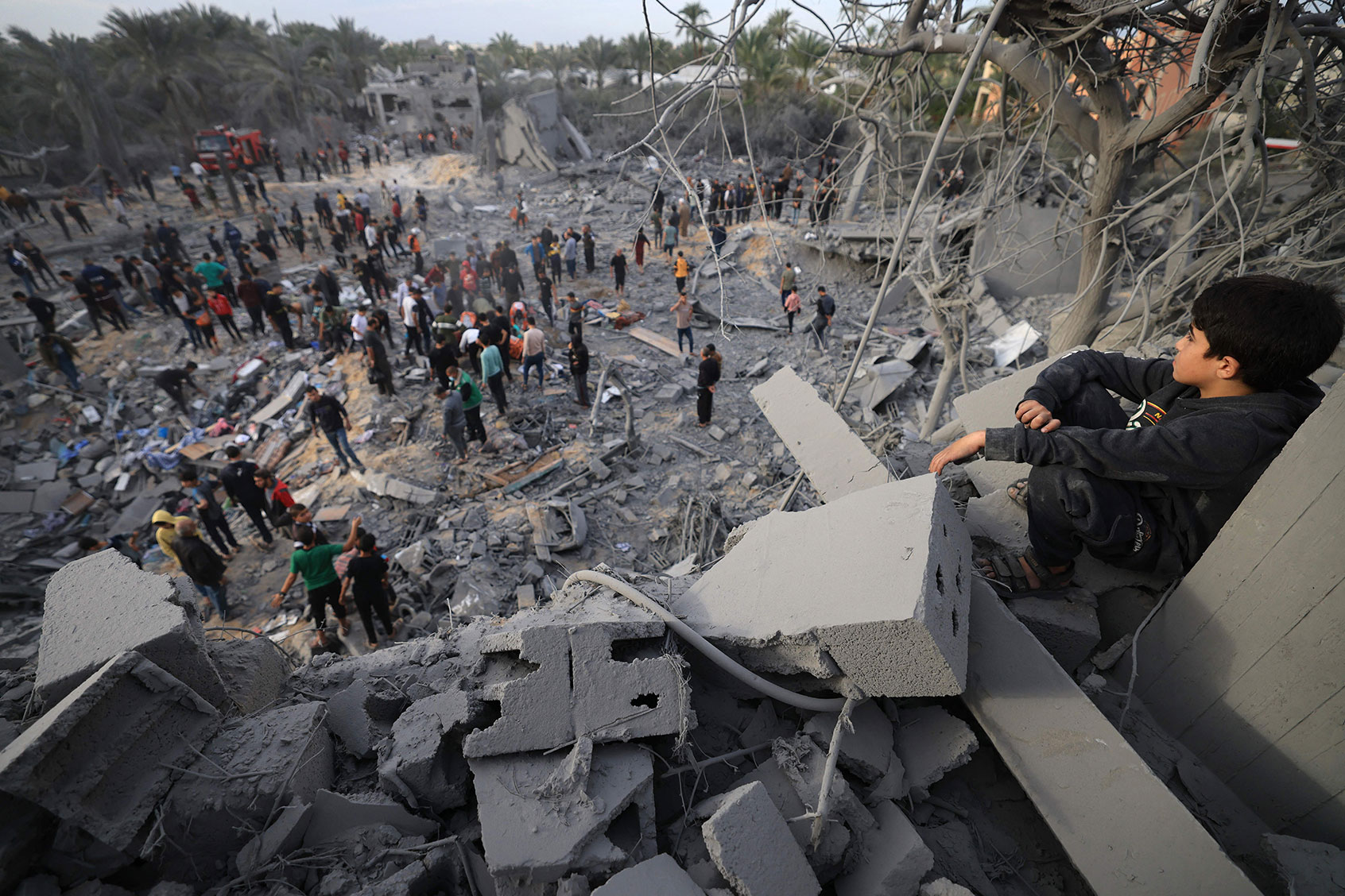 A child looks at the rubble of a house after an Israeli strike in Khan Yunis, in the southern Gaza Strip on November 22, 2023, amid ongoing battles between Israel and the Palestinian Hamas movement. (MAHMUD HAMS/AFP via Getty Images)