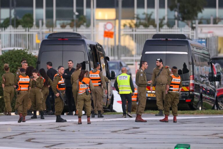 Israeli security forces stand next to buses waiting at the helipad of Tel Aviv's Schneider medical centre on November 24, 2023, amid preparations for the release of Israeli hostages held by Hamas in Gaza in exchange for Palestinian prisoners later in the day. After 48 days of gunfire and bombardment that claimed thousands of lives, a four-day truce in the Israel-Hamas war began on November 24 with 50 hostages set to be released in exchange for 150 Palestinian prisoners. ((Photo by FADEL SENNA / AFP) (Photo by FADEL SENNA/AFP via Getty Images))