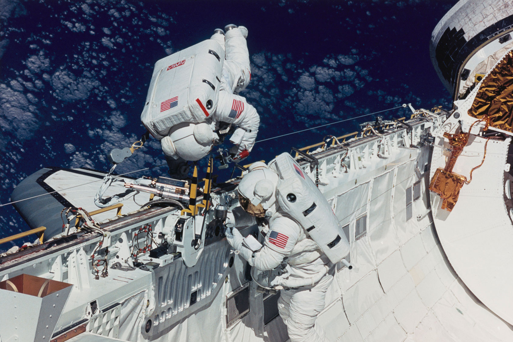 Astronaut James H Newman and Carl E Waltz, mission specialists, practice space walking techniques and evaluate tools to be used on the first Hubble Space Telescope (HST) servicing mission scheduled for later in the year, 16th September 1993. (Space Frontiers/Getty Images)