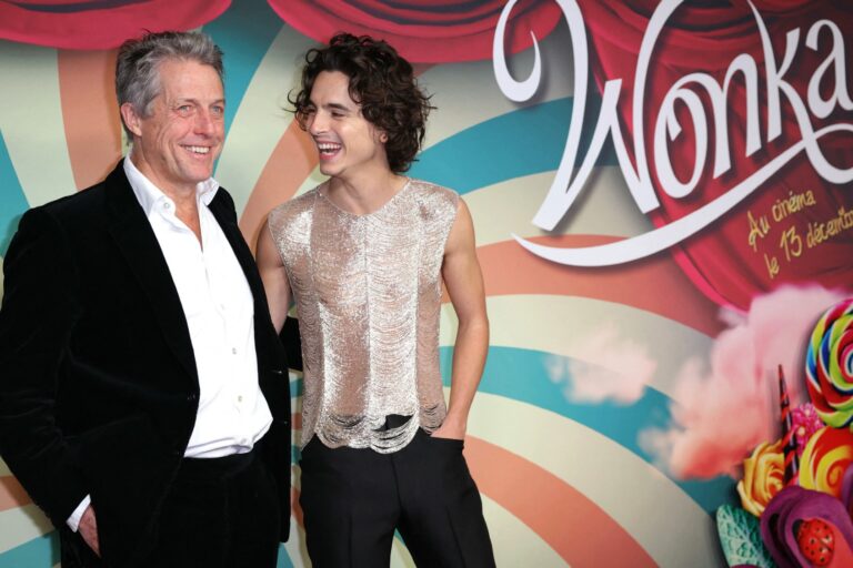 Timothée Chalamet (R) and English actor Hugh Grant pose on the red carpet upon arrival for the Premiere of the film "Wonka" at the UGC Normandie cinema in Paris, on December 1, 2023. (THOMAS SAMSON/AFP via Getty Images)