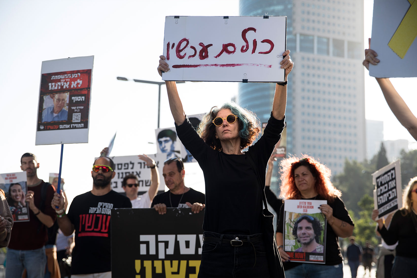 A woman holds a sign saying in hebrew "all now" as famlies of hostages held in Gaza and others protest and call for the release of all hostages on December 1, 2023 in Tel Aviv, Israel. (Amir Levy/Getty Images)