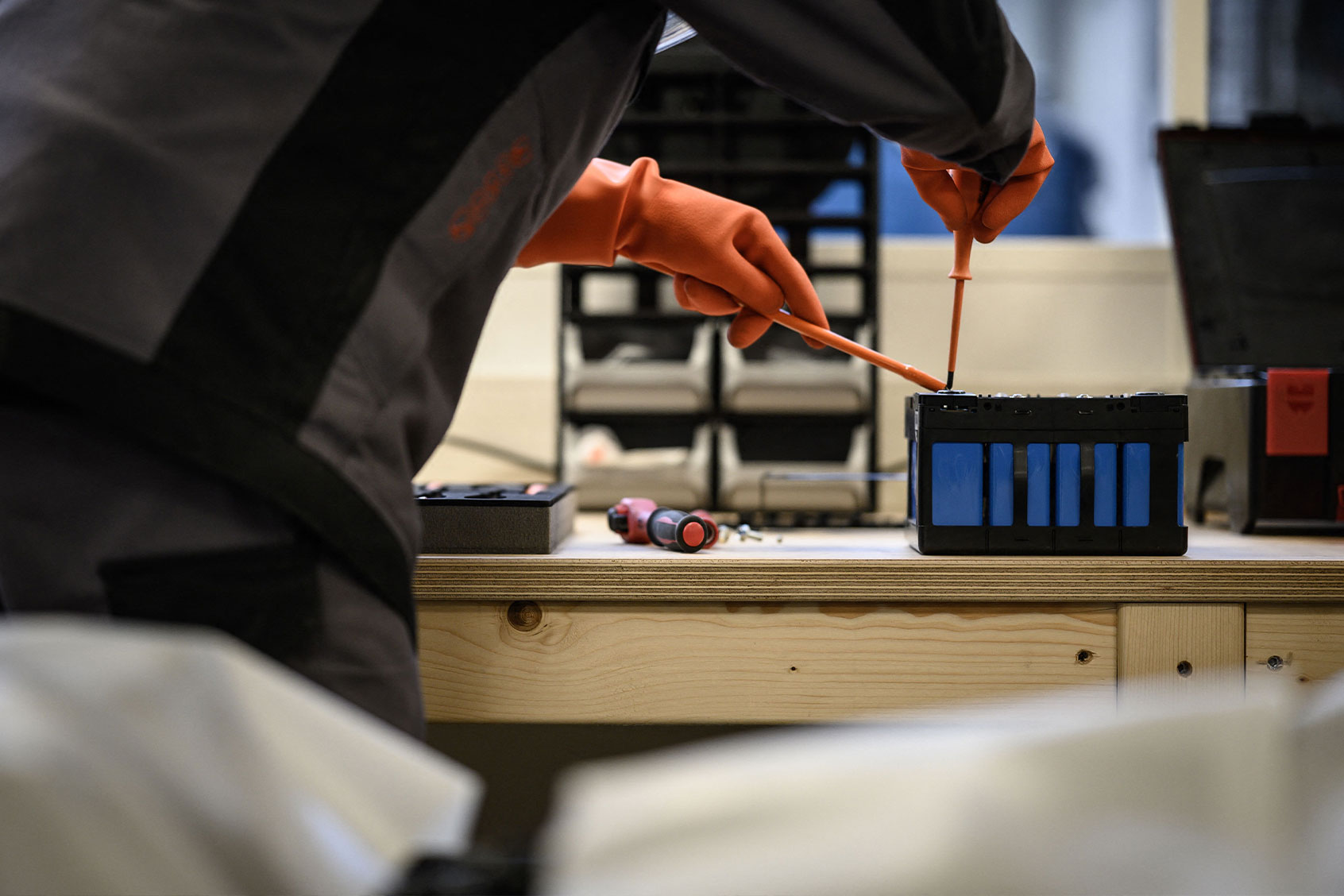 A mechanic works on a battery module of an electric car, at the Revolte e-garage specialized in the electric car repairs, in Carquefou, western France, on November 30, 2022. (LOIC VENANCE/AFP via Getty Images)